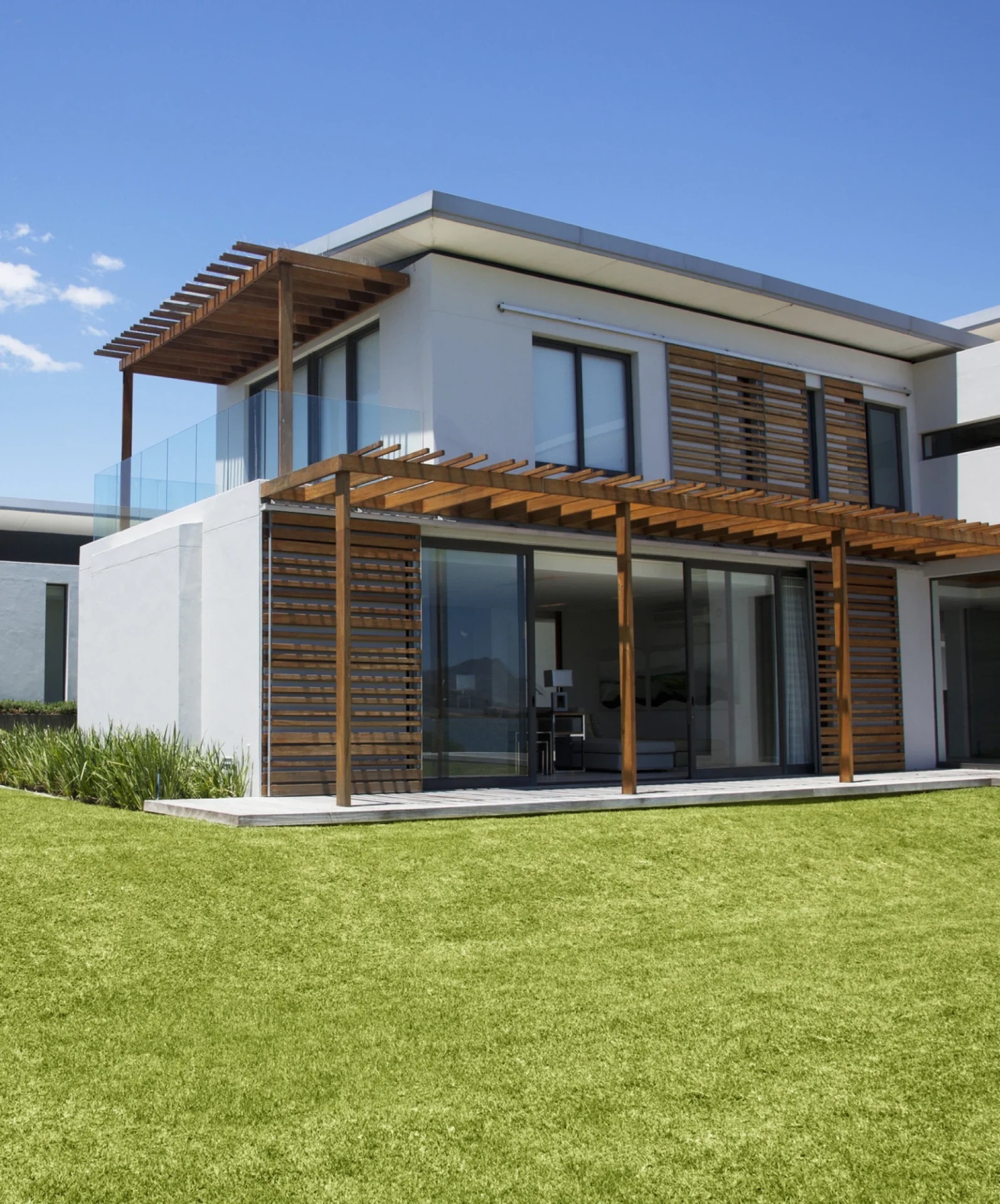 Modern two-story house with wooden pergola.