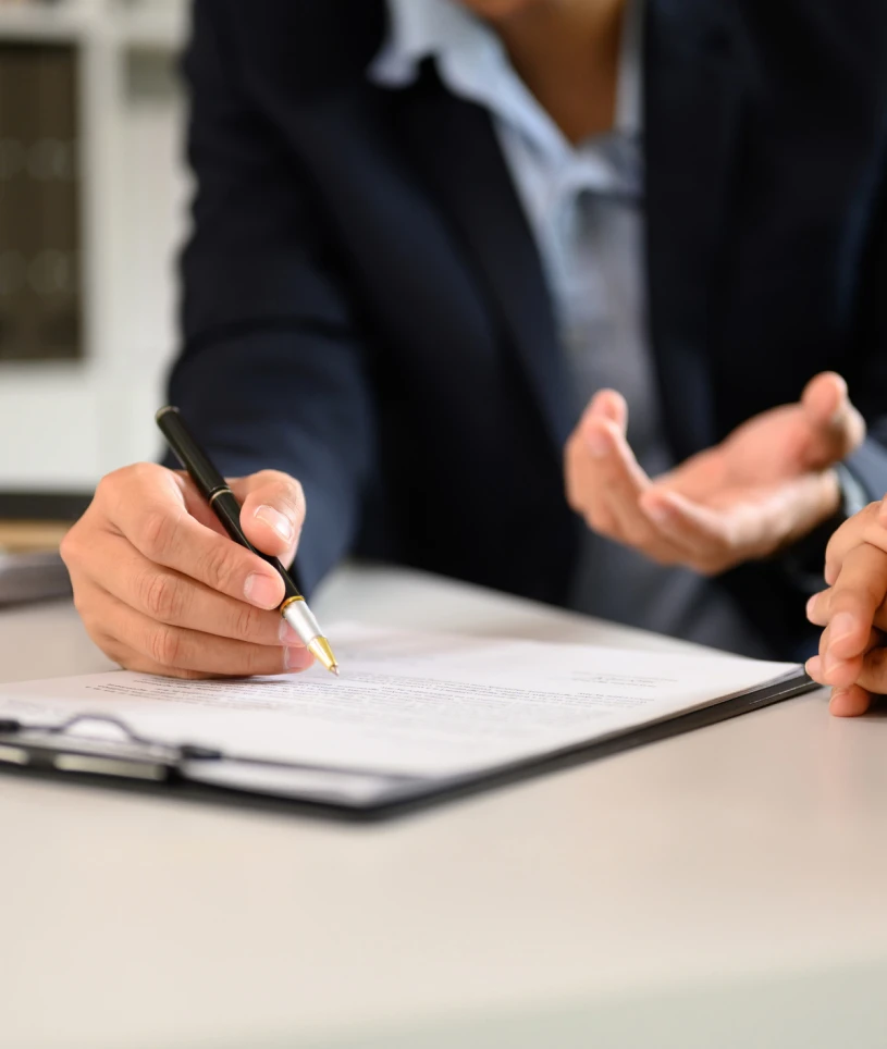 Person signing a contract with pen.