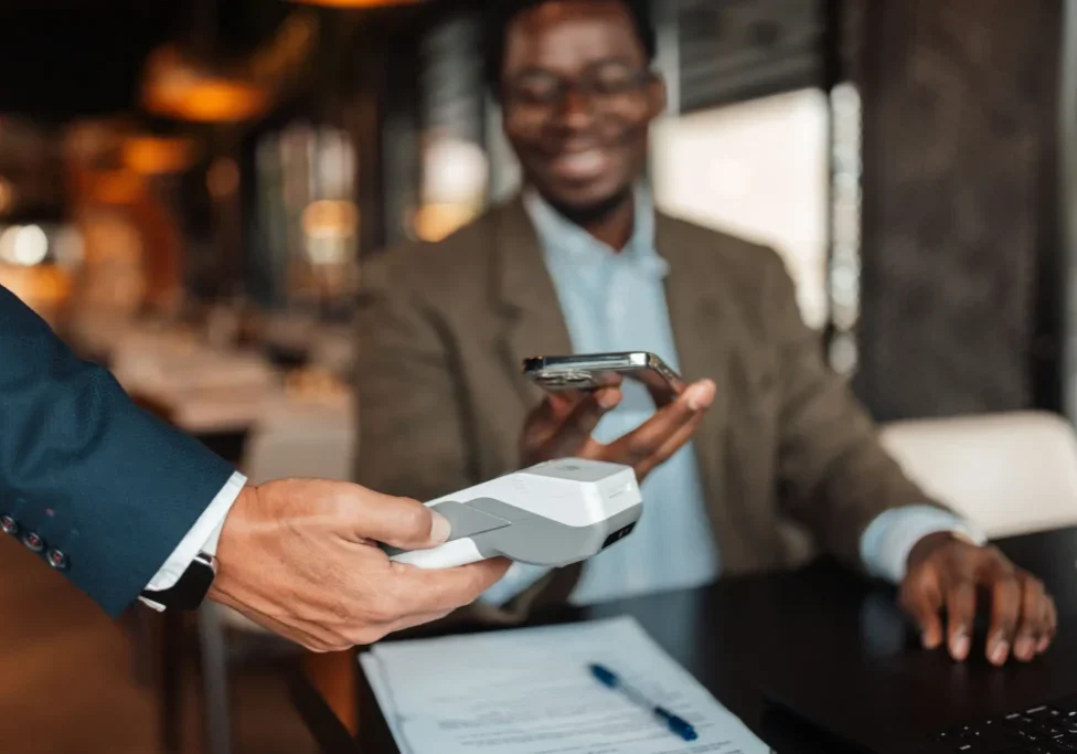 Man using contactless payment with smartphone.